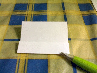 Paper with one edge folded to the centre