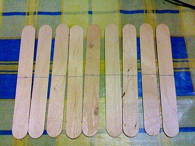 Nine lolly sticks with their middles marked