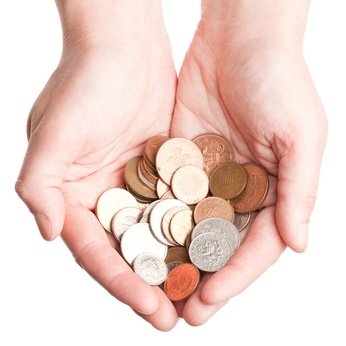 Open hands with a selection of British coins